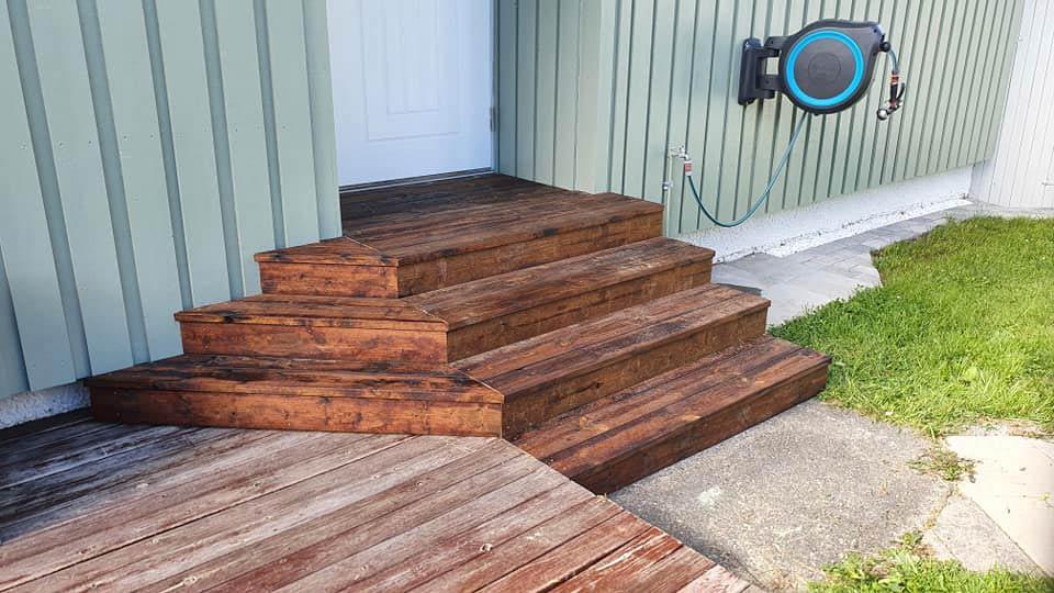 Wide wooden steps built around a corner to a front door