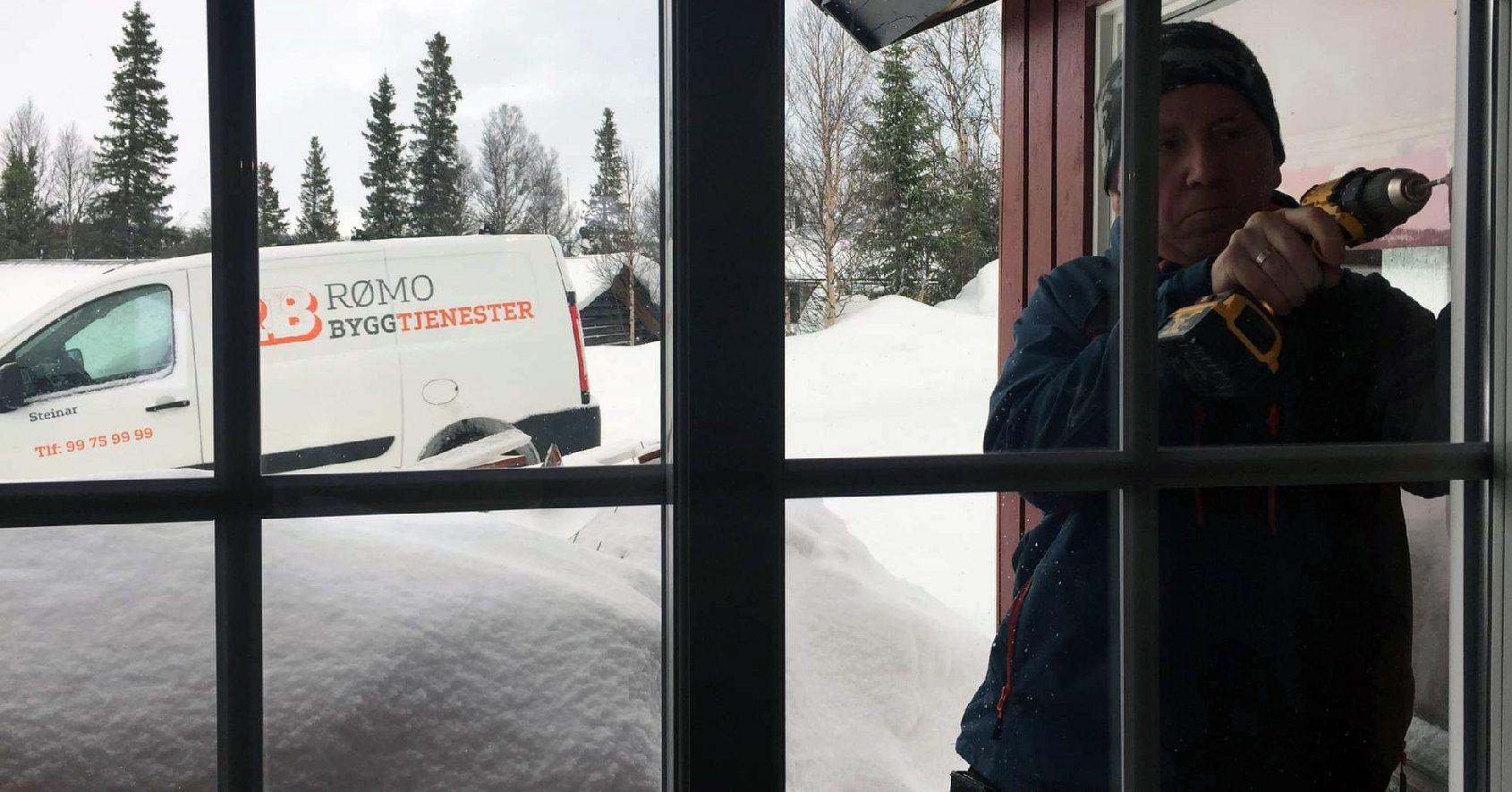 Fitting a new window from the inside, with deep snow and the Rømo van outside